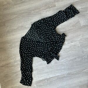 Pretty Little Thing black cropped wrap blouse with white polka dot pattern